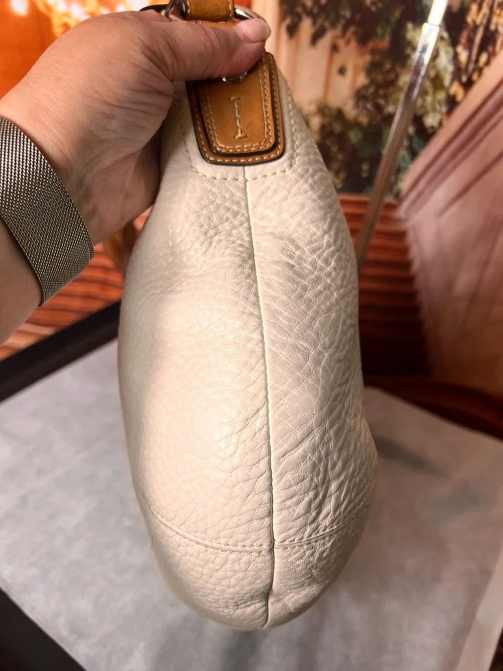 Coach Soho White Pebbled Leather Hobo bag features a distinctive braided handle